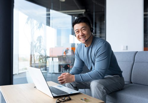 Portrait,Of,Happy,Asian,Call,Center,Worker,,Man,Smiling,And portrait of happy asian call center worker, man smiling and happy working with headset and computer, remote work, video call, online help