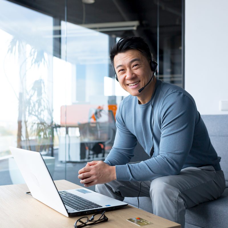 Portrait,Of,Happy,Asian,Call,Center,Worker,,Man,Smiling,And portrait of happy asian call center worker, man smiling and happy working with headset and computer, remote work, video call, online help